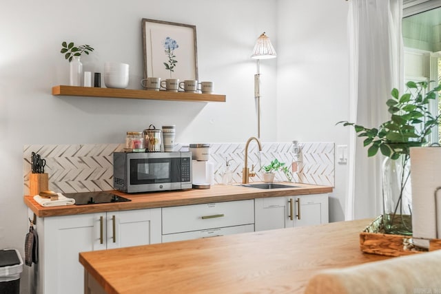 bar with sink, white cabinetry, wood counters, and tasteful backsplash