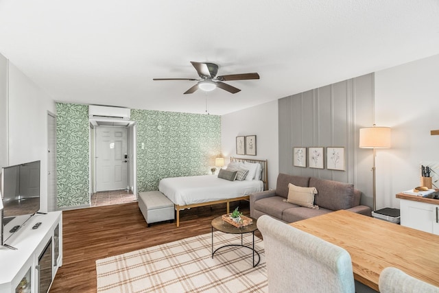 bedroom with ceiling fan, a wall mounted air conditioner, and hardwood / wood-style floors