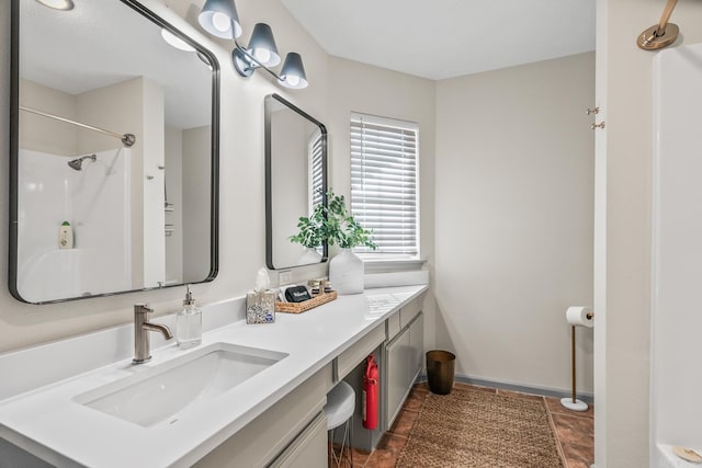 bathroom featuring a shower and vanity