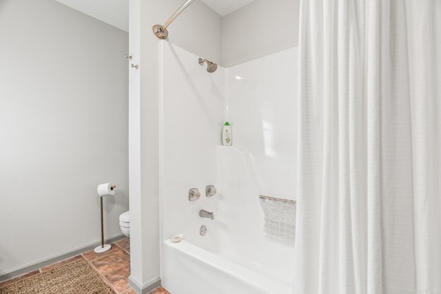 bathroom with shower / bath combo with shower curtain and toilet