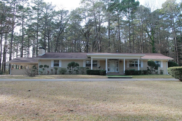 single story home with covered porch, a front yard, and a carport