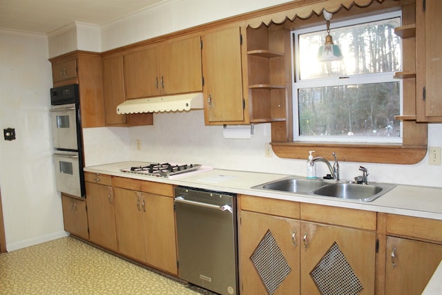 kitchen featuring sink, pendant lighting, ornamental molding, and stainless steel appliances