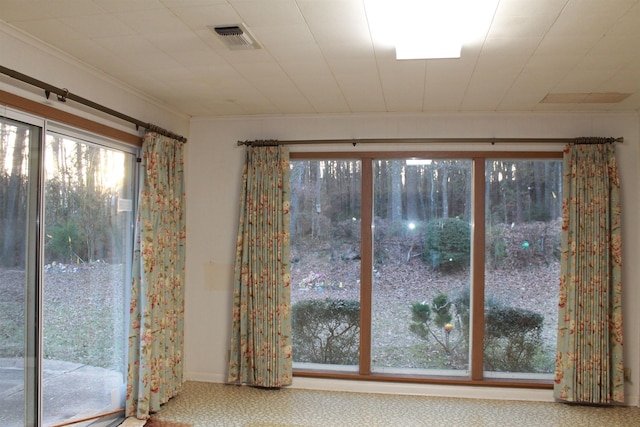 doorway to outside with crown molding