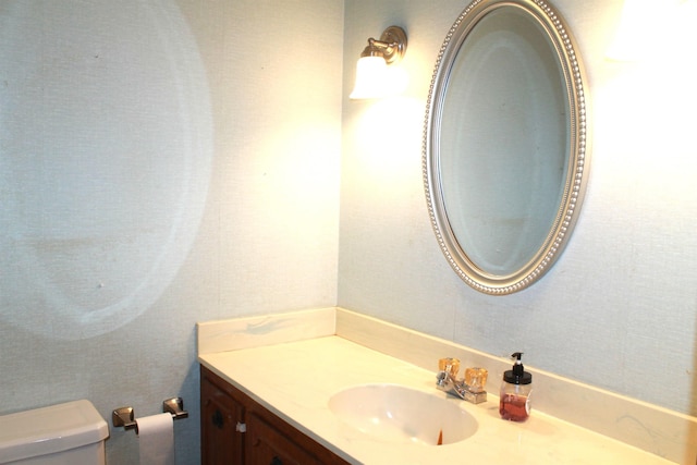 bathroom with toilet and vanity