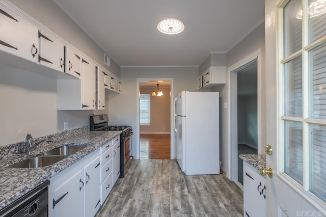 kitchen featuring dishwasher, stainless steel gas stove, white refrigerator, white cabinets, and sink