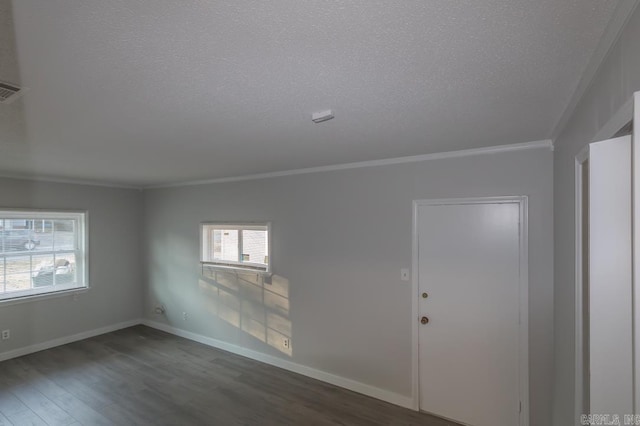 unfurnished room featuring ornamental molding, a textured ceiling, and dark hardwood / wood-style floors