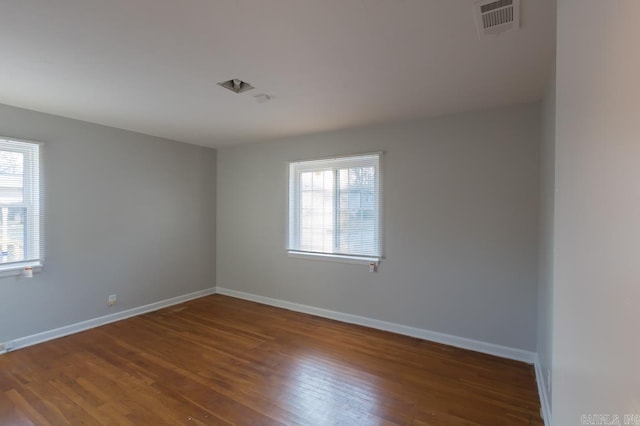 spare room with dark wood-type flooring