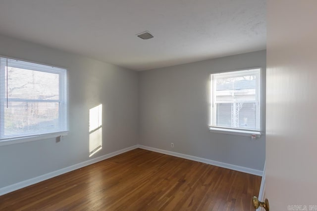 spare room with dark wood-type flooring