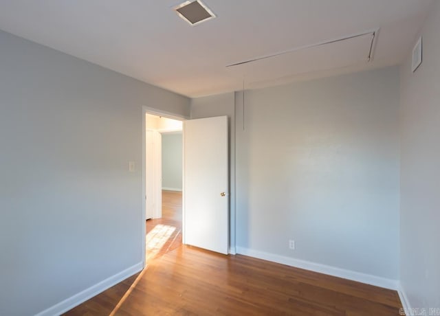 spare room featuring wood-type flooring