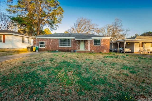 ranch-style home with a carport and a front yard