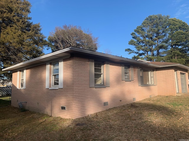 view of side of home with a lawn