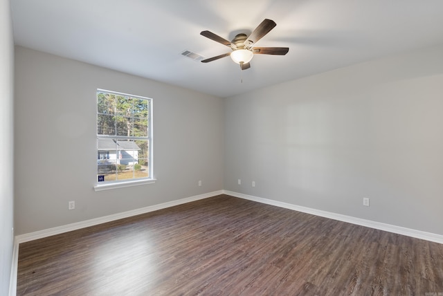 empty room featuring ceiling fan and dark wood-type flooring