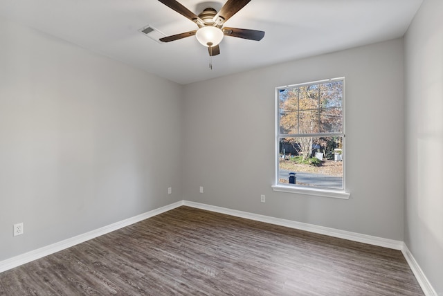 unfurnished room featuring dark wood-type flooring and ceiling fan