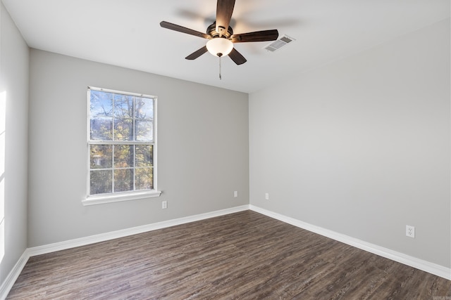 spare room with ceiling fan and dark hardwood / wood-style flooring