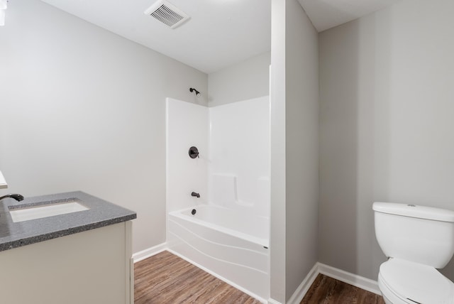 full bathroom with toilet, vanity, bathtub / shower combination, and hardwood / wood-style floors