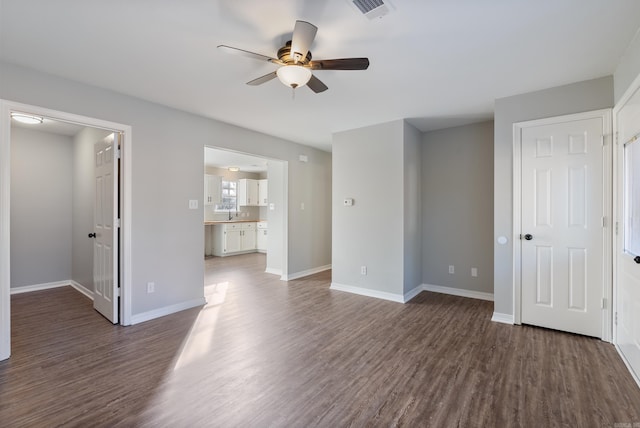 interior space with ceiling fan and dark wood-type flooring