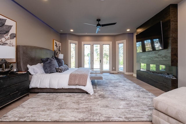 bedroom with ceiling fan, french doors, hardwood / wood-style flooring, and access to exterior