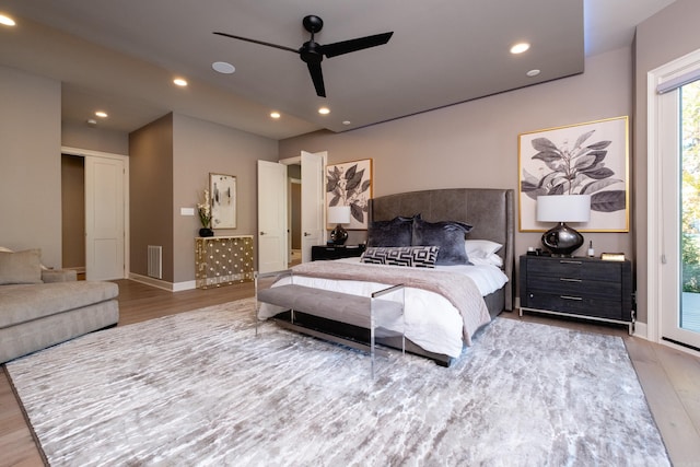 bedroom with hardwood / wood-style flooring, ceiling fan, and access to outside