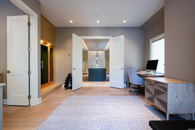 office space with light hardwood / wood-style floors and wood walls