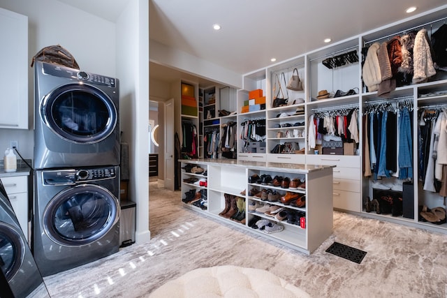 laundry room featuring stacked washer / drying machine