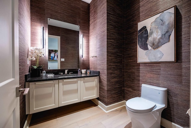 bathroom featuring toilet and vanity