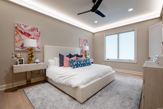 bedroom with ceiling fan and light wood-type flooring