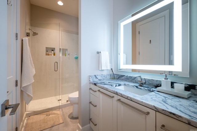 bathroom featuring toilet, tile patterned flooring, an enclosed shower, and vanity