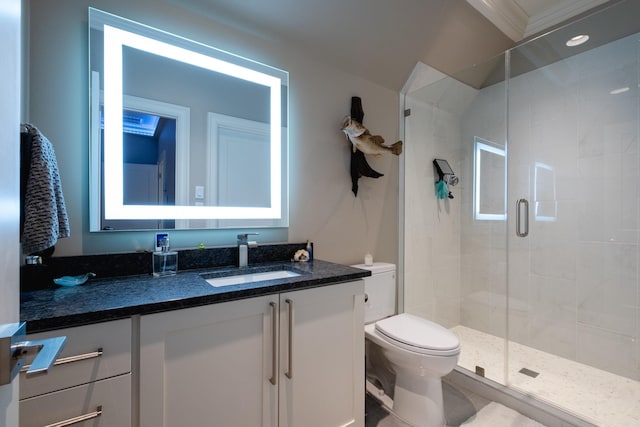 bathroom with toilet, a shower with door, vanity, and crown molding