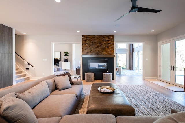 living room featuring ceiling fan, french doors, and light hardwood / wood-style floors