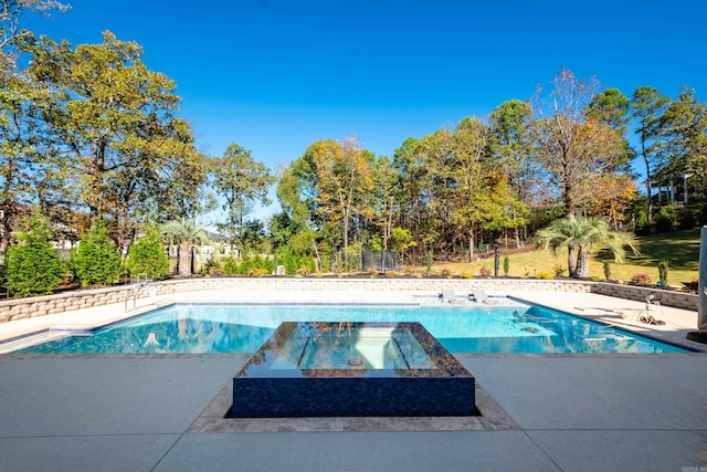 view of pool with an in ground hot tub