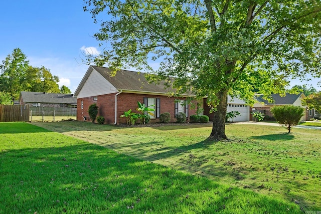 ranch-style house featuring a garage and a front lawn