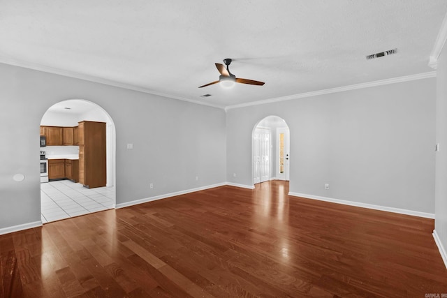 unfurnished room with ceiling fan, ornamental molding, and light hardwood / wood-style floors