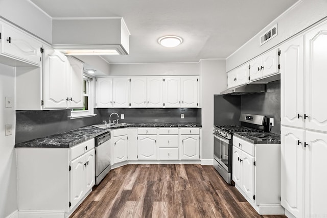 kitchen with sink, appliances with stainless steel finishes, backsplash, and white cabinetry