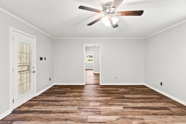 empty room with ornamental molding, ceiling fan, and dark hardwood / wood-style floors