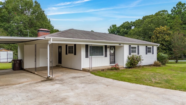 ranch-style home with a front yard and a carport