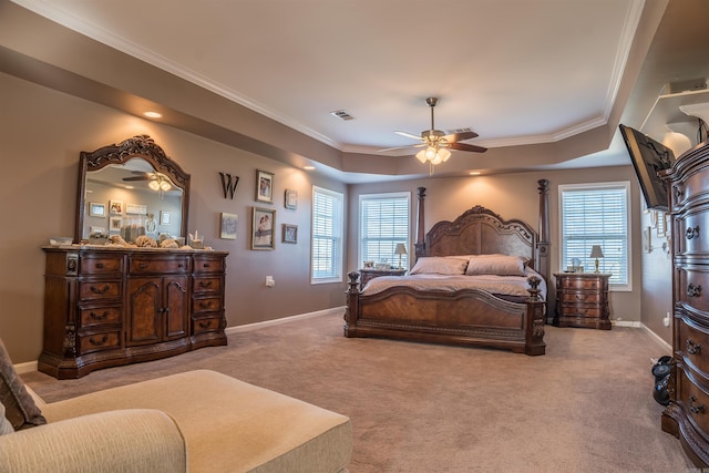 bedroom featuring a raised ceiling, light carpet, ceiling fan, and ornamental molding