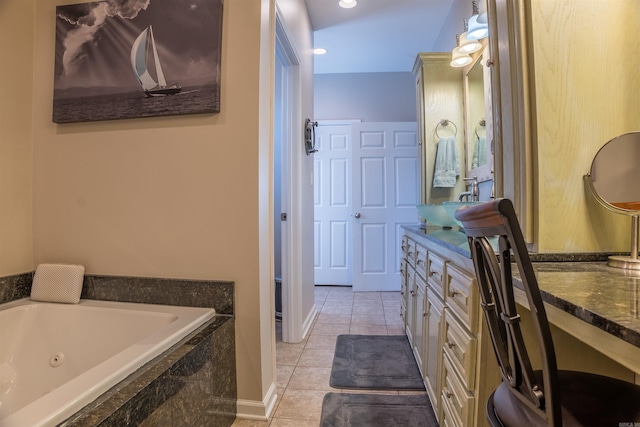 bathroom with vanity, tile patterned floors, and a relaxing tiled tub