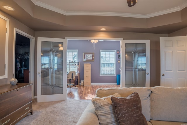 interior space featuring crown molding, french doors, a closet, and a raised ceiling