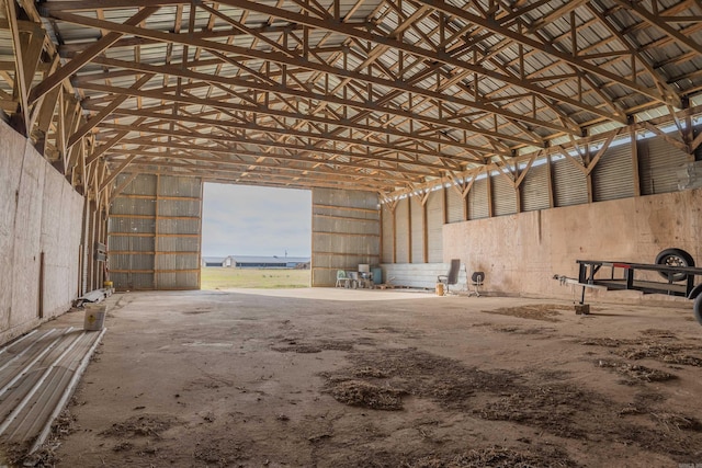 miscellaneous room featuring high vaulted ceiling and concrete flooring