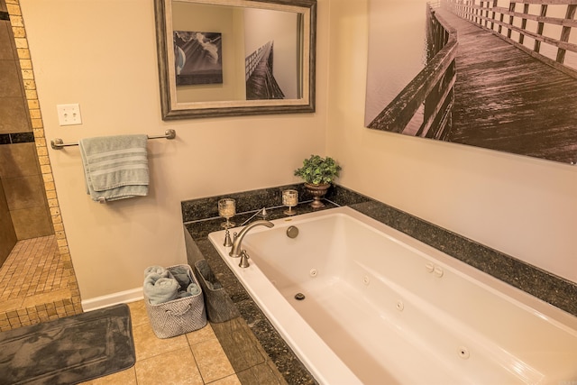 bathroom with a whirlpool tub, tiled shower, tile patterned floors, and baseboards