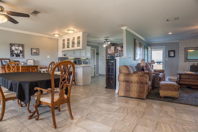 dining area featuring ornamental molding and ceiling fan