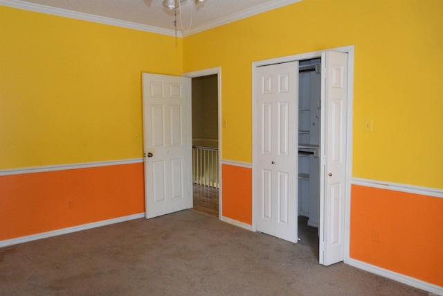 unfurnished bedroom featuring carpet floors, a closet, and crown molding