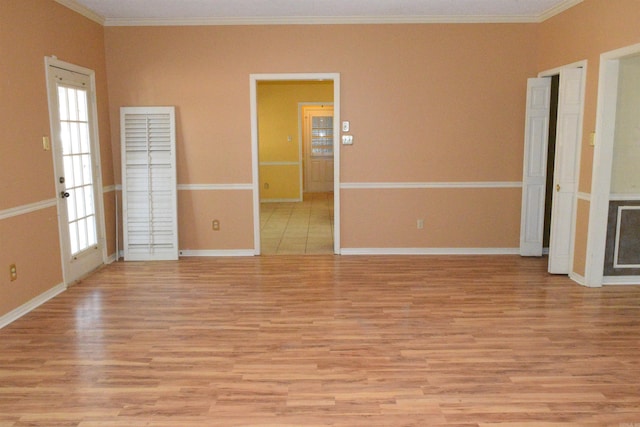 unfurnished room with ornamental molding, light hardwood / wood-style flooring, and plenty of natural light