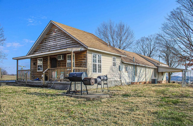 back of house with a yard and central AC unit