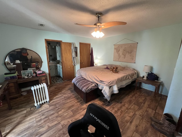 bedroom featuring a textured ceiling, ceiling fan, ensuite bathroom, and wood-type flooring