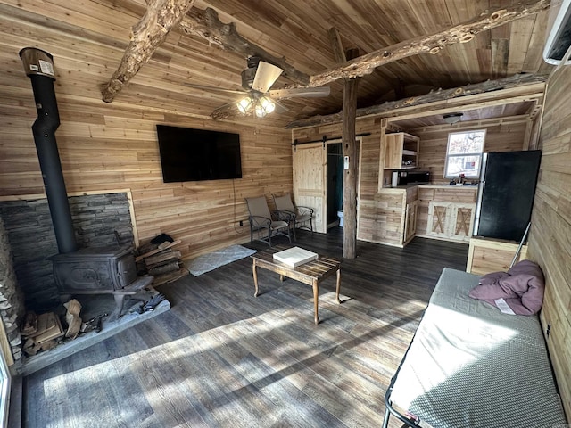 living room with wood ceiling, a wood stove, wood walls, lofted ceiling with beams, and ceiling fan