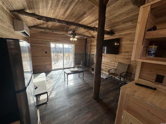 living room featuring a wall mounted AC, beamed ceiling, wooden walls, a wood stove, and wooden ceiling