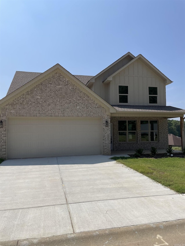 view of front of home with a garage and a front lawn