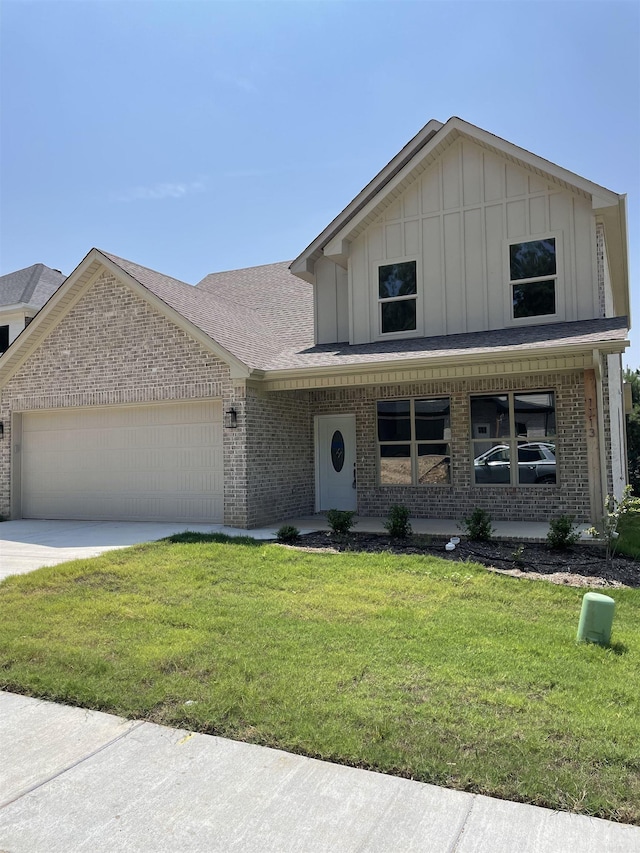 view of front of home featuring a front lawn and a garage