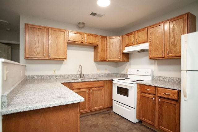 kitchen featuring white appliances, light stone counters, and sink